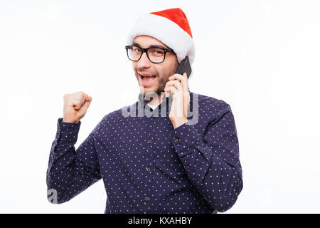 casual young man talking on the phone and cheering . isolated on a white Stock Photo
