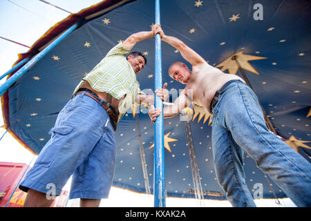 Members of Zavatta family removing pole form big top of circus tent, Zavatta Circus, Kerroch, Morbihan, Brittany, France Stock Photo