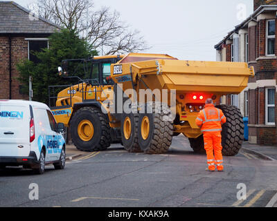 Sheerness, Kent, UK. 8th Jan, 2018. The unusual sight of a giant dumper truck being unloaded, briefly blocking Marine Parade in Sheerness. The Bell articulated dump truck is being used for sea defense work being undertaken by the Environment Agency to move large volumes of shingle. Credit: James Bell/Alamy Live News Stock Photo