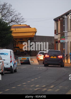 Sheerness, Kent, UK. 8th Jan, 2018. The unusual sight of a giant dumper truck being unloaded, briefly blocking Marine Parade in Sheerness. The Bell articulated dump truck is being used for sea defense work being undertaken by the Environment Agency to move large volumes of shingle. Credit: James Bell/Alamy Live News Stock Photo