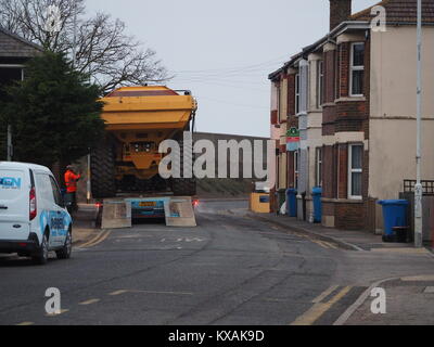 Sheerness, Kent, UK. 8th Jan, 2018. The unusual sight of a giant dumper truck being unloaded, briefly blocking Marine Parade in Sheerness. The Bell articulated dump truck is being used for sea defense work being undertaken by the Environment Agency to move large volumes of shingle. Credit: James Bell/Alamy Live News Stock Photo