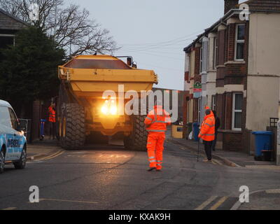 Sheerness, Kent, UK. 8th Jan, 2018. The unusual sight of a giant dumper truck being unloaded, briefly blocking Marine Parade in Sheerness. The Bell articulated dump truck is being used for sea defense work being undertaken by the Environment Agency to move large volumes of shingle. Credit: James Bell/Alamy Live News Stock Photo