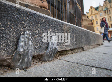 Two mysterious metal hands come out of a crack of a curb of the cathedral of St. Bartholomew in Pilsen, Czech Republic, on January 8, 2018. Officially, nobody knows who gave it into a crack about the end of the last year, or whether it have any meaning. (CTK Photo/Miroslav Chaloupka) Stock Photo