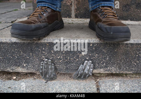 Two mysterious metal hands come out of a crack of a curb of the cathedral of St. Bartholomew in Pilsen, Czech Republic, on January 8, 2018. Officially, nobody knows who gave it into a crack about the end of the last year, or whether it have any meaning. (CTK Photo/Miroslav Chaloupka) Stock Photo