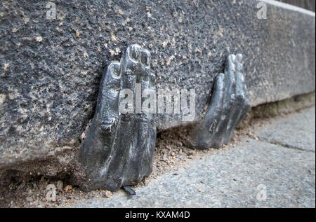 Two mysterious metal hands come out of a crack of a curb of the cathedral of St. Bartholomew in Pilsen, Czech Republic, on January 8, 2018. Officially, nobody knows who gave it into a crack about the end of the last year, or whether it have any meaning. (CTK Photo/Miroslav Chaloupka) Stock Photo