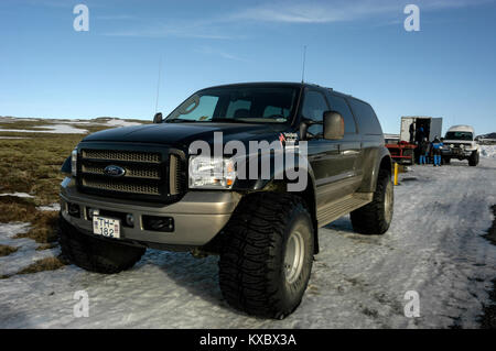 A customised 4x4 tourist carrying vehicle, fitted with 44 inch tyres for rough terrain driving in remote ice/snow areas  of Iceland Stock Photo