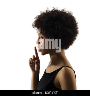 one mixed race african young teenager girl woman Hushing portrait in studio shadow silhouette isolated on white background Stock Photo