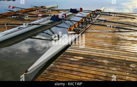 Rowing shell at side of Jetty. Stock Photo