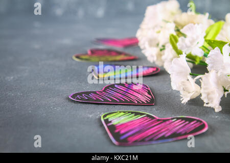 Homemade Black violet pink hearts on a gray concrete background. The concept of Valentine's Day. A symbol of love Stock Photo