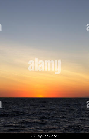 Sunset over the Pacific Ocean on the equator at the Galapagos Islands. Useful for backgrounds. Stock Photo