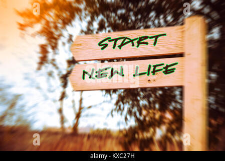 Wooden signpost with two arrows over speed effect backgroun, Start new life signs, Life change conceptual image Stock Photo