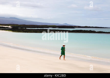 Galapagos -  tourist jogging on the beach on holiday, San Cristobal Island, Galapagos Islands Ecuador South America Stock Photo