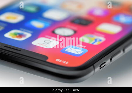 Closeup of Apple iPhone X smartphone corner with a colorful display focused on the mail app Stock Photo