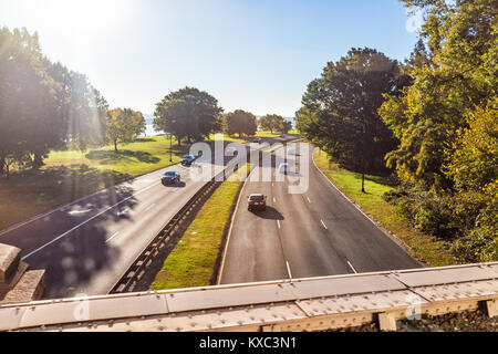 Virginia, USA - October 27, 2017: Aerial view of George Washington Memorial Parkway with cars from overpass, mount Vernon sign and Potomac river, sun Stock Photo