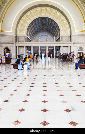 Washington DC, USA - October 27, 2017: Inside Union Station in capital city with transportation signs and people walking, waiting, sitting on benches  Stock Photo