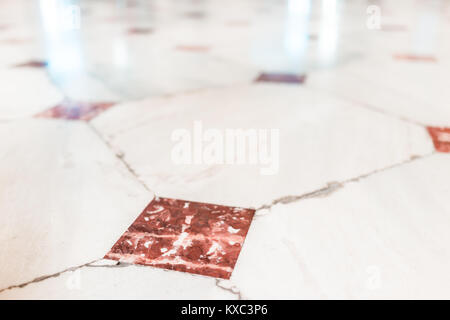 Closeup of red, orange tiled marble floor squares with bokeh Stock Photo