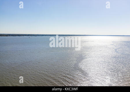 Delaware river seascape during sunny bright day with industrial coast and sunlight Stock Photo