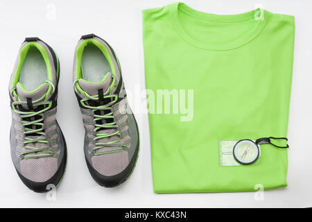 Outdoors shoes, t- shirt and magnetic compass for trail running, free running, fast climbing, hiking, studio shoot on white background Stock Photo