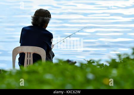 Old man fishing Stock Photo