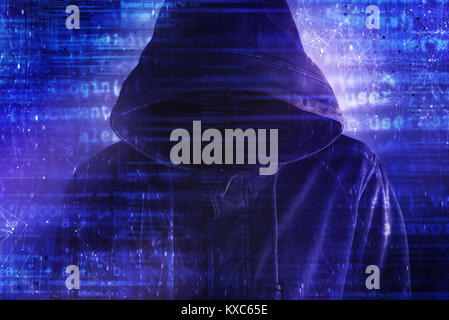 Cybersecurity, computer hacker with hoodie and obscured face, computer code overlaying image Stock Photo