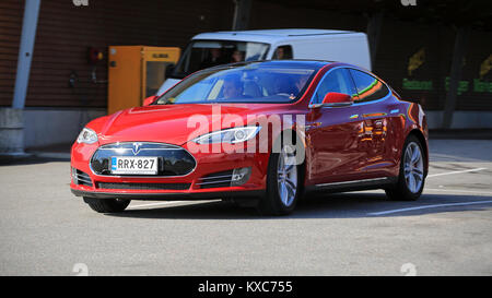 SALO, FINLAND - SEPTEMBER 6, 2014: Tesla Model S fully electric car in motion. In 2013, Tesla delivered 22,477 vehicles to customers worldwide. Stock Photo