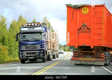 HAMEENLINNA, FINLAND - AUGUST 28, 2014: Volvo FH16 logging truck and another trailer truck on the road. According to Statistic  Finland, the Cost inde Stock Photo