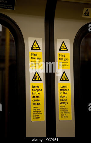 Mind the gap warning on London Underground train railway carriage doors. Notice signs Stock Photo