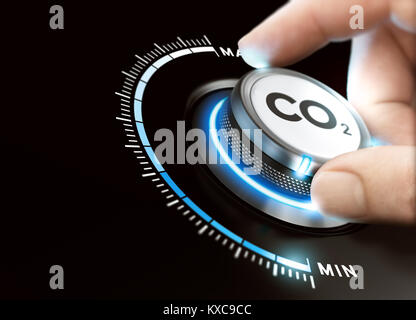 Man turning a carbon dioxyde knob to reduce emissions. CO2 reduction or removal concept. Composite image between a hand photography and a 3D backgroun Stock Photo