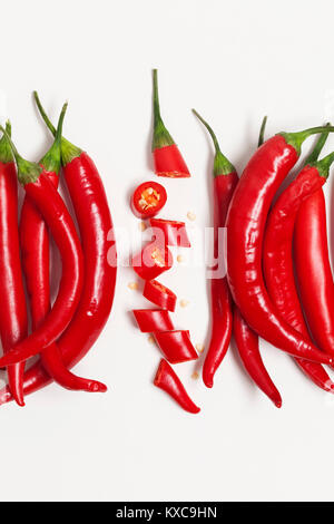 Sliced red chili pepper arranged on a plain background Stock Photo