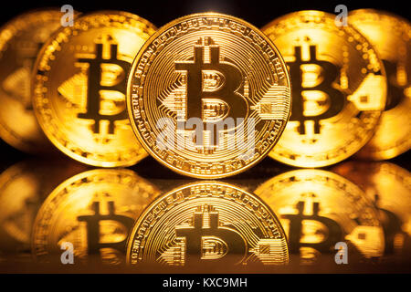 Five Virtual Coins Bitcoins On Printed Circuit Board. Stock Photo