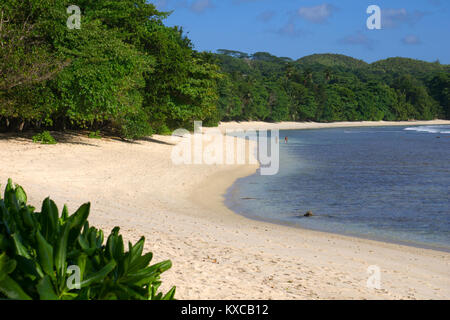Walking on the beach in the Seychelles Stock Photo