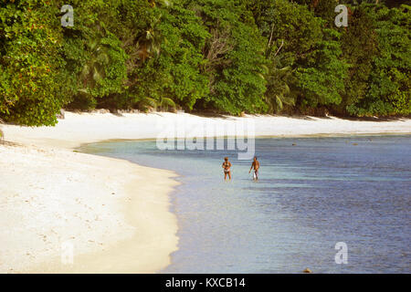 Walking on the beach in the Seychelles Stock Photo