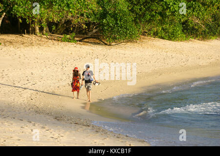 Walking on the beach in the Seychelles Stock Photo