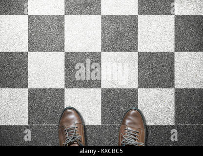 businessman stand on chess tile floor Stock Photo