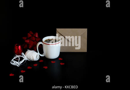 Valentines day or wedding still life scene with cup of coffee, envelope, paper hearts confetti and decorative gift ribbons over black background. Love Stock Photo