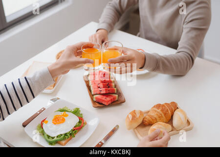 Two male friends eating breakfast at home in morning. Stock Photo