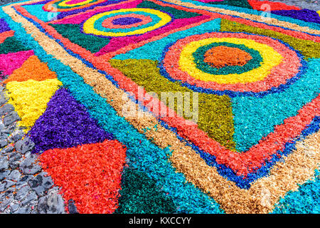 Antigua, Guatemala -  March 25, 2016: Handmade dyed sawdust Good Friday procession carpet in town with famous Holy Week celebrations Stock Photo