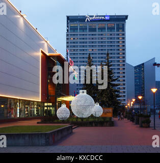 VILNIUS, LITHUANIA - DECEMBER 30, 2017: Christmas light balls and fir trees decorate the park near the Central Shop and the Radisson Blue Hotel in Lit Stock Photo