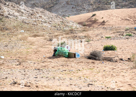 Garbage left in Desert, Discarded plastic bags, bottles, and other waste cluttering a desert landscape, environmental impact of litter in remote areas Stock Photo