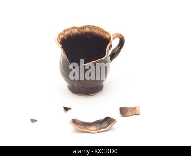 broken brown ceramic cup on a white background Stock Photo