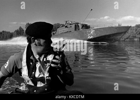 AJAXNETPHOTO. 1971. RIVER SEINE, FRANCE. - 38 KNOTS TO LE HAVRE - HMS SABRE VOYAGE TO PARIS - RECON UNIT; TWO CREW MANNED THE SHIP'S SMALL INFLATABLE ON SOME STRETCHES OF THE RIVER, ADVISING THE MOTHER SHIP OF ONCOMING TRAFFIC ROUNDING BLIND RIVER BENDS.  PHOTO:JONATHAN EASTLAND/AJAX REF:RX7151204 139 Stock Photo