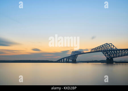 Tokyo Gate Bridge over bay against sky during sunset Stock Photo