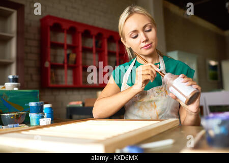 Pretty Young Woman Working in Art Studio Stock Photo