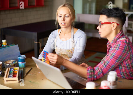 Two Interior Designers Working Together in Art Studio Stock Photo