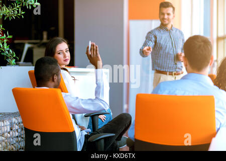African american Business people Raising there Hand Up at a Conference to answer a question Stock Photo