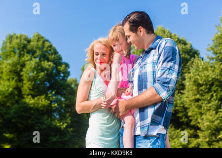 Happy family holding each other cheek to cheek Stock Photo