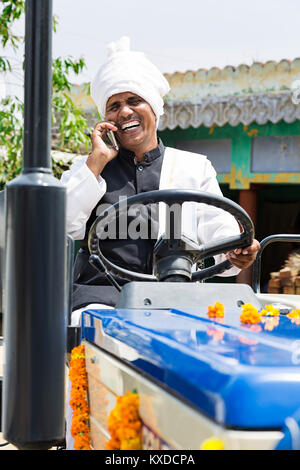 1 Indian Rural Farmer Man Sitting Tractor Talking Mobile Phone Stock Photo