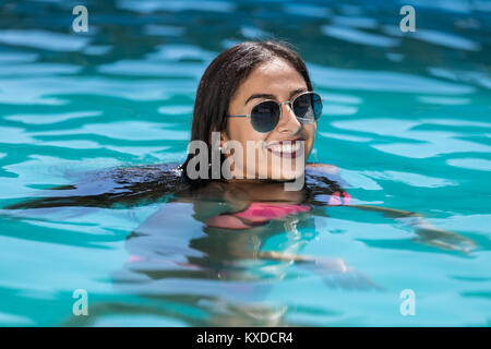 Young woman smiling in the pool Stock Photo