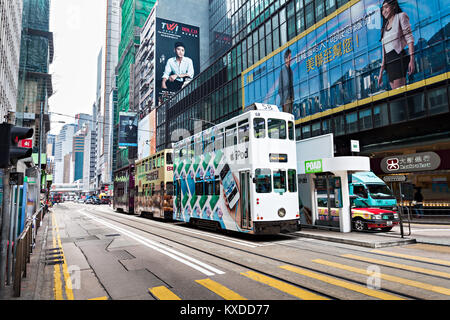 HONG KONG - FEBRUARY 21: Double trams with advertisements at Hennessy Rd. Road show provides advertisements to the passengers of public vehicles on Fe Stock Photo