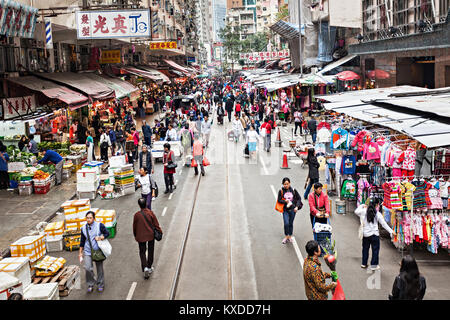 HONG KONG - FEBRUARY 21 : Street market in Central district on February 21, 2013 in Hong Kong. People buying and selling fruit, meat, fish and vegetab Stock Photo